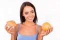 Cute girl chooses between a healthy food and harmful food Royalty Free Stock Photo