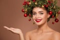 Girl with christmas wreath on her head. Brown background