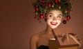 Girl with christmas wreath on her head. Open magic gift box Royalty Free Stock Photo