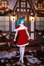 Cute girl cosplaying Christmas Miku santa dress