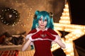 Cute girl cosplaying Christmas Miku santa dress