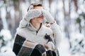 Cute girl covering boyfriend`s eyes by her knitted mittes. Winter wedding. Artwork. Royalty Free Stock Photo