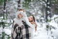 Cute girl covering boyfriend`s eyes by her knitted mittes. Winter wedding. Artwork. Royalty Free Stock Photo