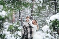 Cute girl covering boyfriend`s eyes by her knitted mittes. Winter wedding. Artwork. Royalty Free Stock Photo