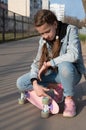 cute girl in denim and pink sneakers and penny board, longboard . International Skateboarding Day. Royalty Free Stock Photo