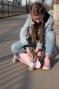 cute girl in denim and pink sneakers and penny board, longboard . International Skateboarding Day. Royalty Free Stock Photo