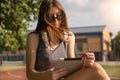 Breezy Learning: Cute Girl Engrossed in Education Amidst Park Serenity