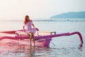 Cute girl dipped her legs in the water sitting on the boat Royalty Free Stock Photo