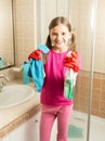 Cute girl doing cleaning at bathroom holding rag and spray Royalty Free Stock Photo