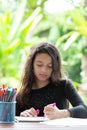 Cute girl doing her homework in the garden at home Royalty Free Stock Photo