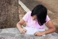 Cute girl doing homework in the park Royalty Free Stock Photo