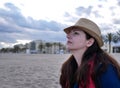 Cute girl dreaming sitting on the beach