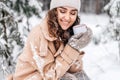 Cute girl sitting in the snow with her eyes closed with a white cup Royalty Free Stock Photo