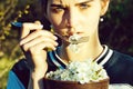 Cute girl eating cherry blossom petals with metallic fork Royalty Free Stock Photo