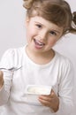 Cute girl eating yogurt Royalty Free Stock Photo