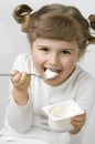 Cute girl eating yogurt Royalty Free Stock Photo
