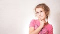 Cute girl eight years old with Curly hair on gray background