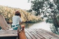girl enjoy with the nature resting and looking on the river Royalty Free Stock Photo
