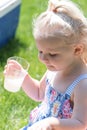 Young girl drinking lemonade outside on a hot summer day Royalty Free Stock Photo