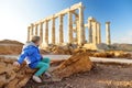 Cute girl exploring the Ancient Greek temple of Poseidon at Cape Sounion, one of the major monuments of the Golden Age of Athens Royalty Free Stock Photo