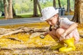 Cute girl exploring the nature with magnifying glass outdoors, Child playing in the forest with magnifying glass. Royalty Free Stock Photo