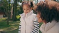 Cute girl feeding pigeons with mother at sunny park close up. Child having fun Royalty Free Stock Photo