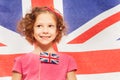 Cute girl with flag, banner of England behind Royalty Free Stock Photo