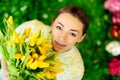 Cute girl with flowers on green grass