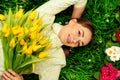 cute girl with flowers on green grass