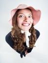 Cute girl with funny hat smiling in the studio Royalty Free Stock Photo