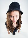 Cute girl with funny peasant hat smiling in the studio Royalty Free Stock Photo