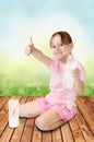 Cute girl gives the thumbs-up