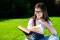 Cute Girl Reading Book Outdoors
