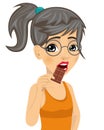 Cute girl with glasses eating chocolate