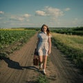 Cute girl goes on a dirt road Royalty Free Stock Photo