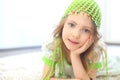 Cute girl green hat white carpet Royalty Free Stock Photo