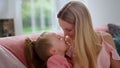 Cute girl and happy mother touching noses. Smiling woman playing with daughter Royalty Free Stock Photo