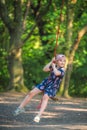 Cute girl having fun on a line swing in summer