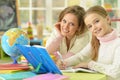 Cute girl with her mother doing homework Royalty Free Stock Photo