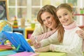 Cute girl with her mother doing homework Royalty Free Stock Photo