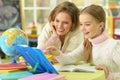 Cute girl with her mother doing homework Royalty Free Stock Photo