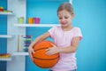 Cute girl holding basket ball Royalty Free Stock Photo