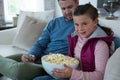 Cute girl holding bowl full of popcorn Royalty Free Stock Photo