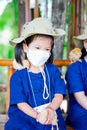 Cute girl holding chick. Small chicken sits on little girl`s shoulder. Children wear white mask to prevent spread virus and PM2.5