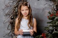 Girl holding Christmas gift near xmas tree Royalty Free Stock Photo