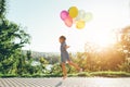 Cute girl holding colorful balloons in the city park, playing, r Royalty Free Stock Photo