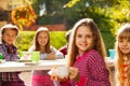 Cute girl holding cupcake and cup with her friends Royalty Free Stock Photo