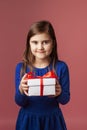 Cute girl holding a gift.