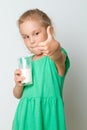 Cute girl holding glass of milk