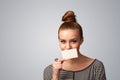 Cute girl holding white card at front of her lips with copy space Royalty Free Stock Photo